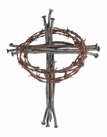 A cross made from rusty nails and a crown of thorns made from barbed wire.