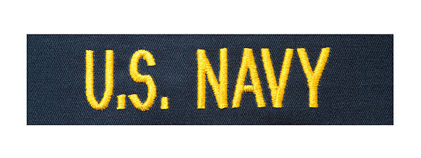 A blue fabric patch with the U S NAVY written in yellow  stock photo