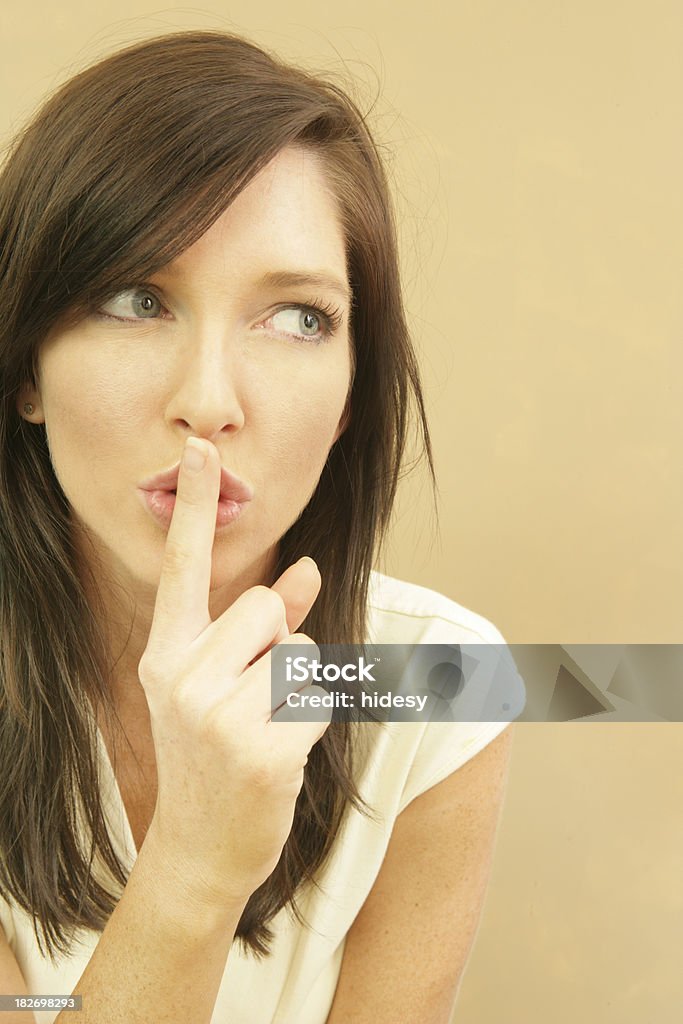 Taboo Woman gestures for silence. 20-24 Years Stock Photo