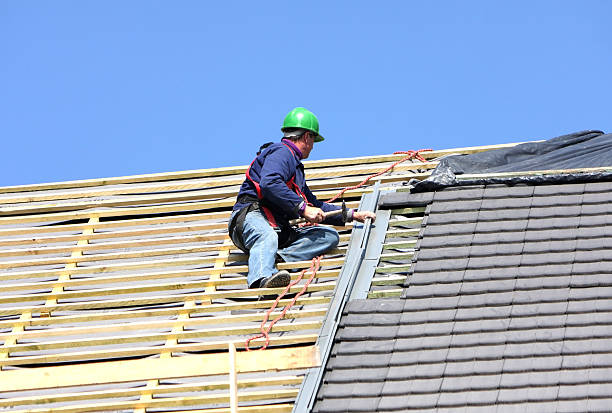 istock Man in green hard hat working a roof 182698330