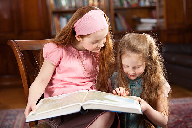 istock Girls at home, finding a place on the map 182698711