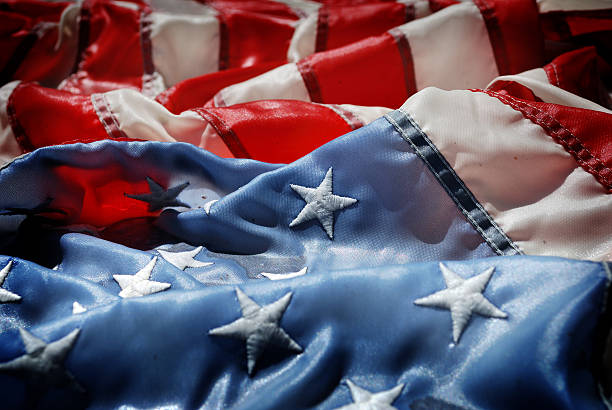 istock Sun Reflects on a Soaking Wet Crumpled Faded American Flag 182698751
