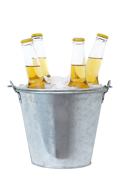 Four beer bottles in ice in a metal bucket Four bottles of beer in a bucket of ice, on white. Check out some other White Backgrounds here bucket stock pictures, royalty-free photos & images