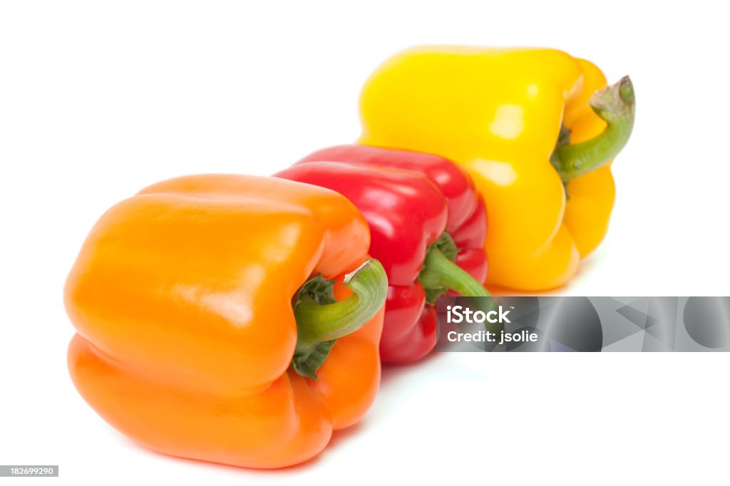 Red, Orange and Yellow Bell Peppers Fresh red, orange and yellow Bell peppers isolated on white. Bell Pepper Stock Photo