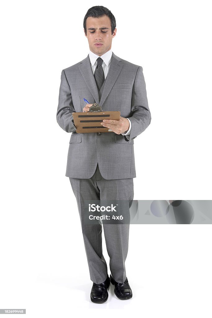 Geschäftsmann macht Notizen in Zwischenablage - Lizenzfrei Klemmbrett Stock-Foto