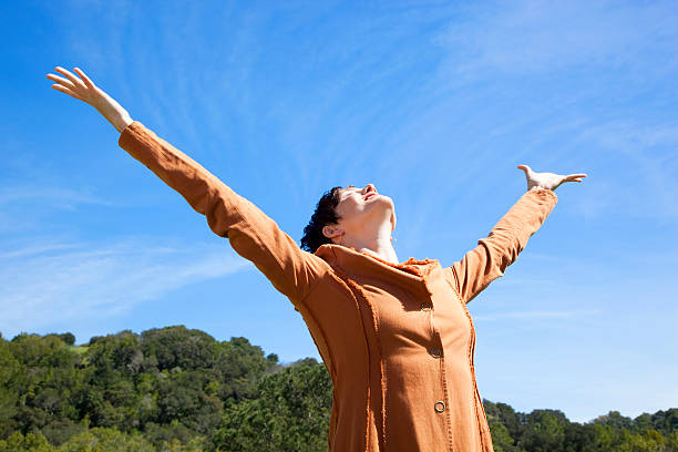 istock ecstatic woman with arms outstretched 182700008