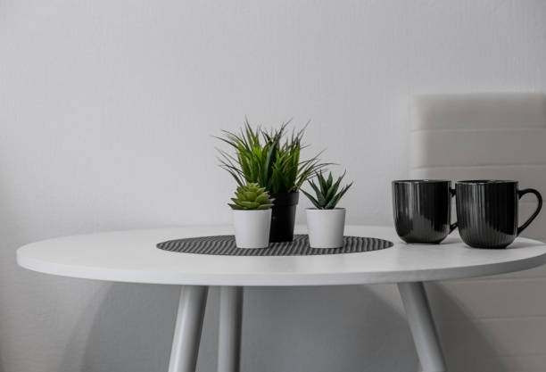 istock a white kitchen table. round table with mugs and flowers in the kitchen 1827000797