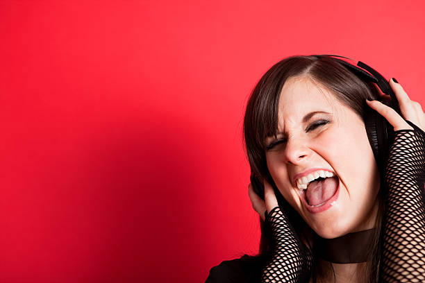 istock Happy Rocker Girl Singing While Wearing Headphones 182700159