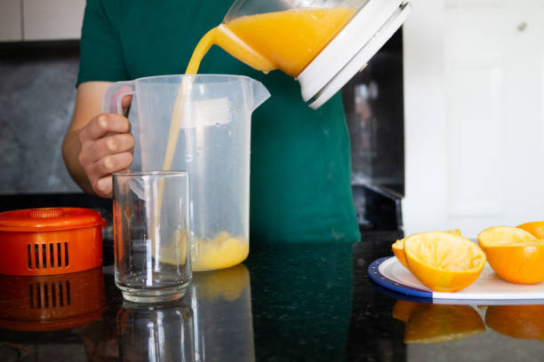 istock a man preparing a healthy breakfast with orange juice 1827010275
