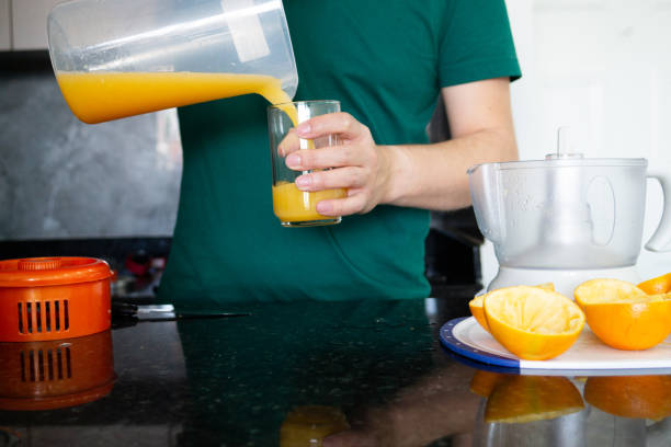 istock a man preparing a healthy breakfast with orange juice 1827010281