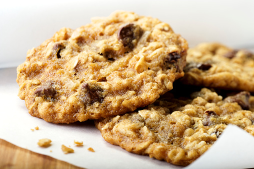 close-up image of chocolate chips cookies on a wooden background. Place for text. Top view.