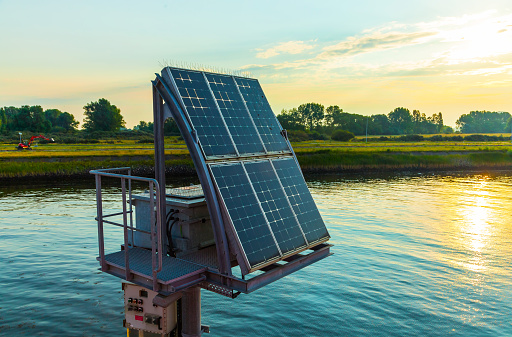 A mooring station with a solar panel installed on it in the bay near the coast.