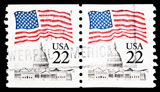 Royalty free stock photo of US postage stamp.It represents US flag over Capitol with the city of Washington and the Washington Monument in the background