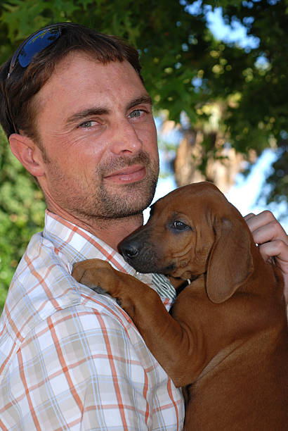 istock Man greeting his Puppy 182702081