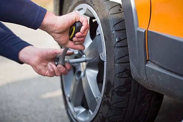 Changing tires summer tires are mounted on a car flat tire stock pictures, royalty-free photos & images