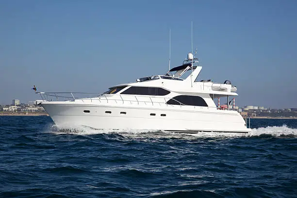 Motor yacht cruising in Southern California waters near Marina Del Rey, CA with American flag on stern