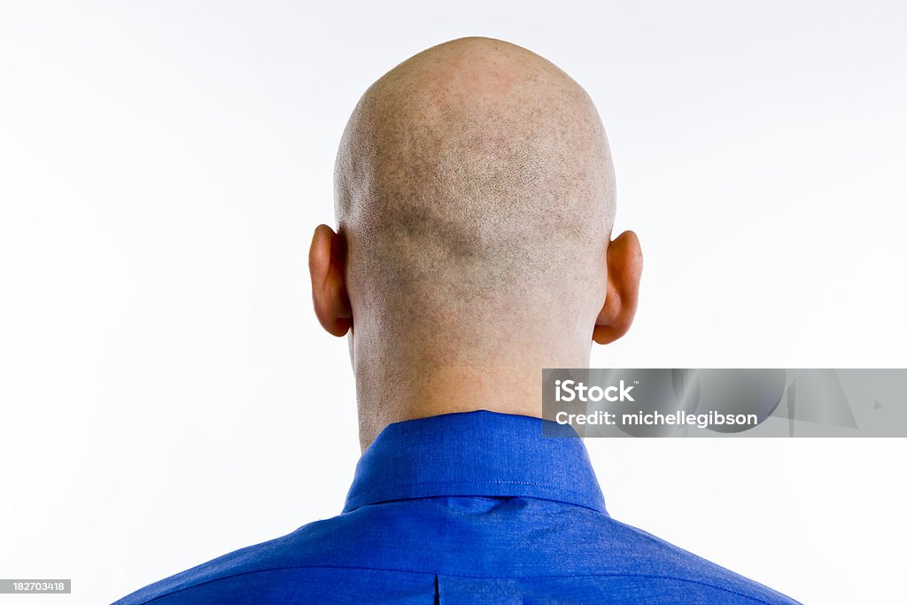 Bald Head Man stands with back of his bald shaved head towards the camera Back Of Head Stock Photo