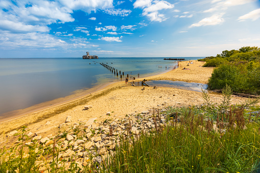 Gdynia, Poland - July 24 2023: Babie Doly beach with old ruins of pier and ruins of torpedo room on the Baltic sea