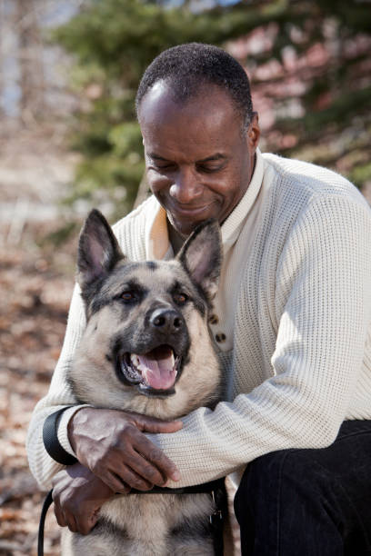 Mature adult male with German Shepherd