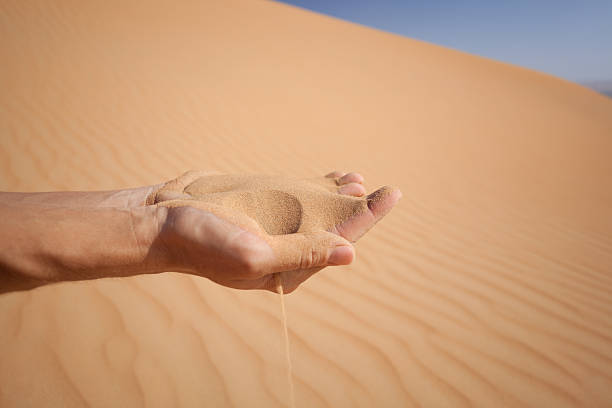 istock hand can«t hold sand shot in desert 182704967