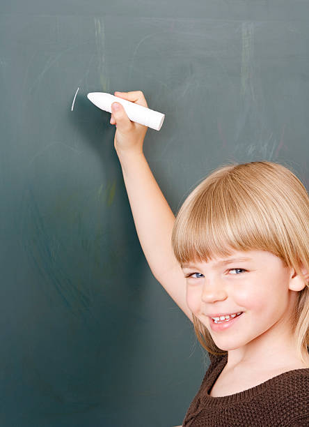 istock Young girl with chalk at the blackboard 182705689