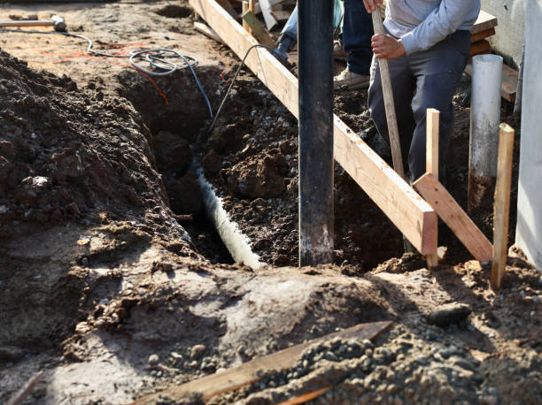 istock Setting the new drain pipe in the trench 1827057443