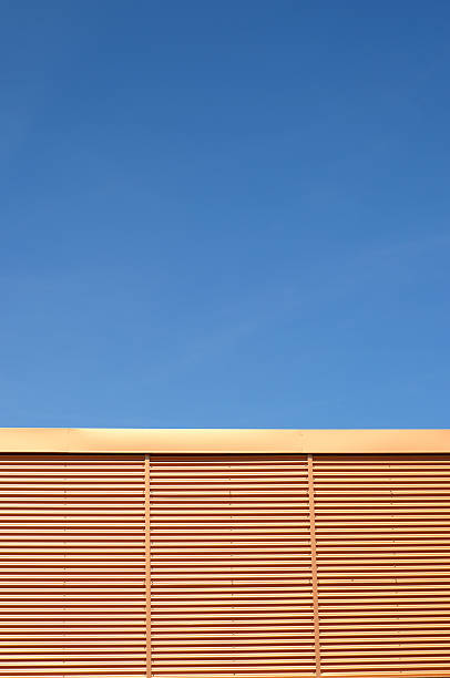 istock Modern building with gold siding and blue sky. 182705882