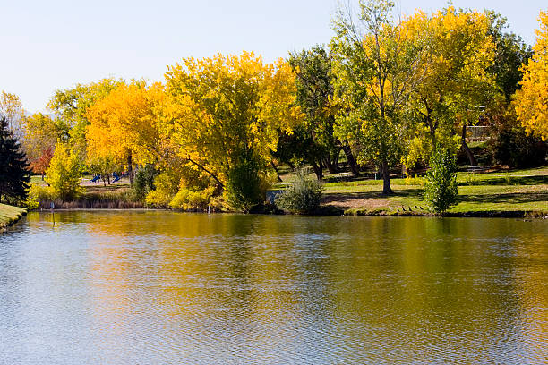 Beautiful autumn scene of a lake Beautiful autumn scene of a lake in historic Arvada Colorado.   arcada stock pictures, royalty-free photos & images