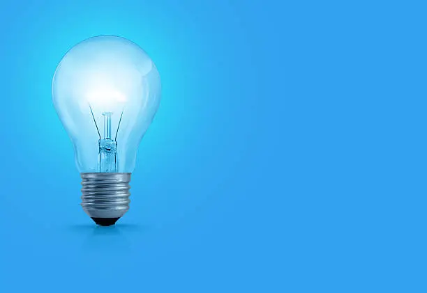 Photo of Light Bulb On Blue Background
