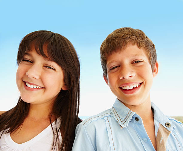 istock Cute young brother and sister smiling together 182707044