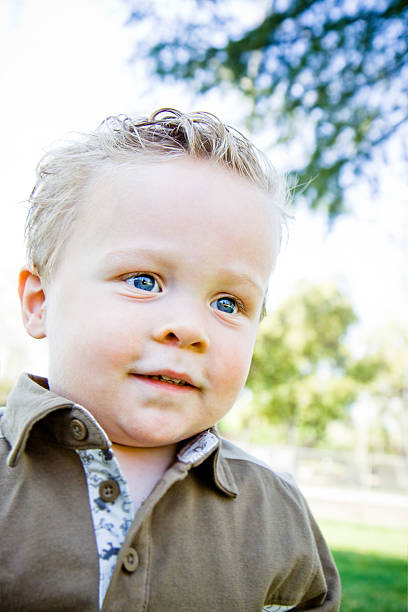 istock cute little boy looking into the distance 182707107
