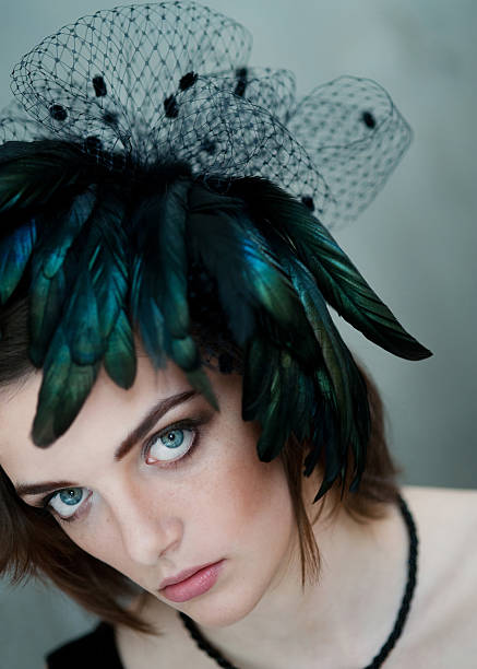 woman with dramatic feather hat stock photo