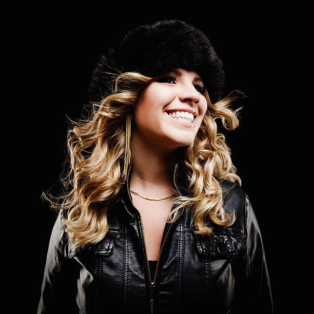 Smiling Young Woman In Fur Hat and Jacket. Isolated. stock photo