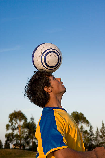 istock Soccer Player Balancing Ball on Head 182707783
