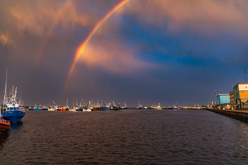 Wladyslawowo, Poland - July 24 2023: Beautiful double rainbow over boats docked at the port after long storm over the Baltic sea