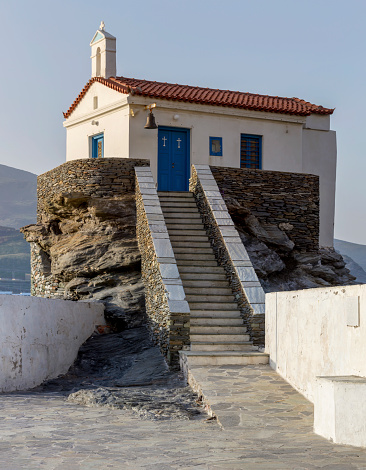 View of white, Christian, Orthodox church in the town close-up (Andros Island, Greece, Cyclades) in spring day
