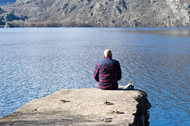 istock Man on the shore of a lake. 1827082263