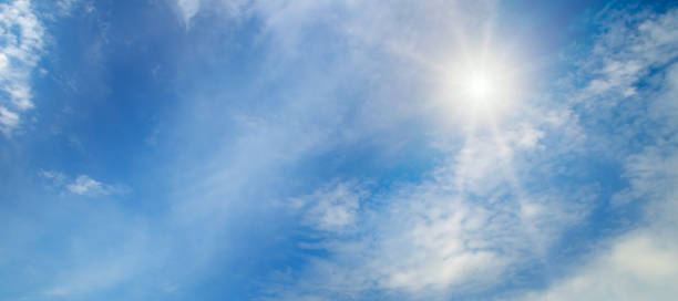 istock Light clouds and sun in the blue sky. Wide photo. 1827082777