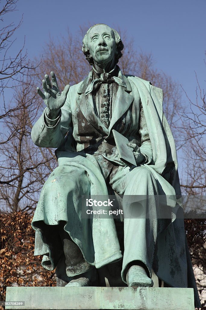 Hans Christian Andersen world famous poet in Kongens Have Sculpture of World Famous Danish fairy tale writer and poet Hans Christian Andersen (1805 - 1870) on his favourite spot in the Royal Garden (Kongens Have) Park of Copenhagen ready to read for the children.This (1823 - 1916) statue by August Saabye was errected in 1880.Other Hans Christian Andersen related pictures from my portfolio: Author Stock Photo