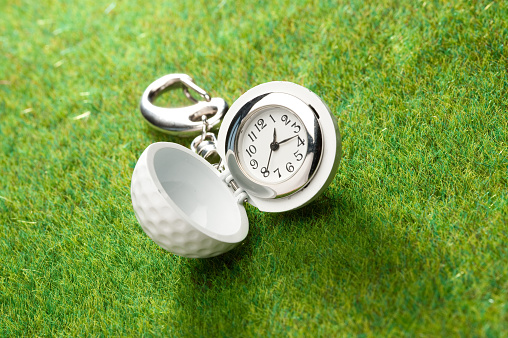 Keychain keyring golf ball with clock on grass