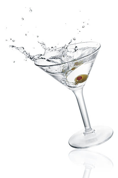 splashing cocktail (XXXL) glass of cocktail with olive and splash martini glass photos stock pictures, royalty-free photos & images