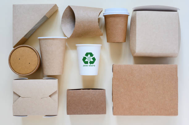 istock Zero waste concept and use of environmentally friendly materials. Paper eco-friendly tableware and recycling sign on white cup 1827095993