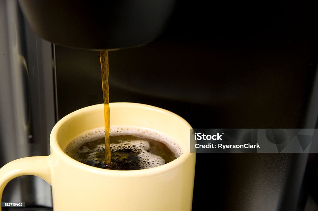 Morning Coffee. Coffee is dispensed from a machine into a bright yellow mug or cup.  Click to view similar images. Coffee - Drink Stock Photo