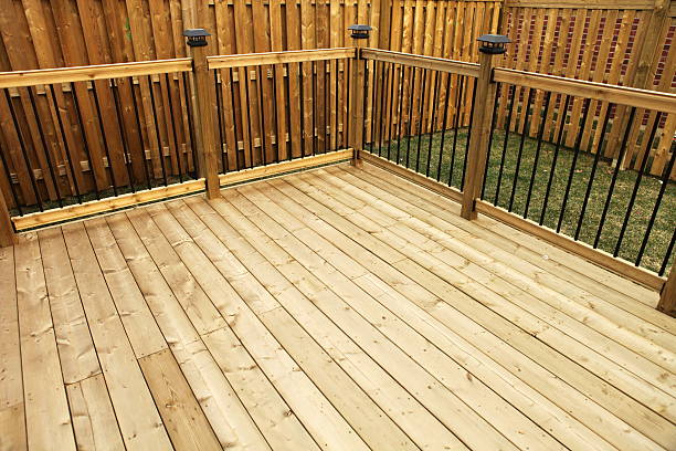 New Wooden Deck Wood deck with railing and wooden fence in the background. decking stock pictures, royalty-free photos & images