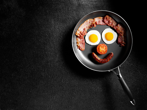Breakfast in a frying pan with copy space on a dark slate background.Click on the links below to see related images.