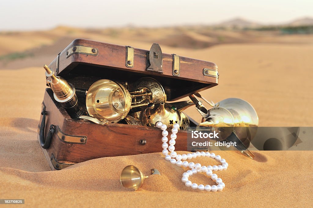 treasure hunt arabian origin treasures in a wooden chest lying on the desert sand. image taken in dubai Treasure Chest Stock Photo