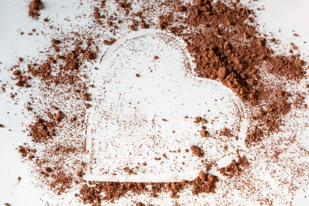 istock Heart shape made of powdered cocoa on a white surface. 1827117264
