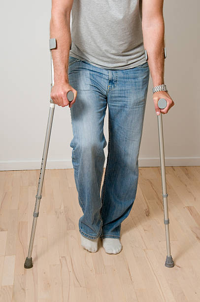 istock Man with crutches and an ankle or knee injury 182713007