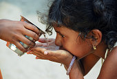 Child in solidarity act provides water to another