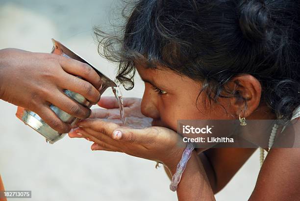 Child In Solidarity Act Provides Water To Another Stock Photo - Download Image Now - Water, Assistance, India